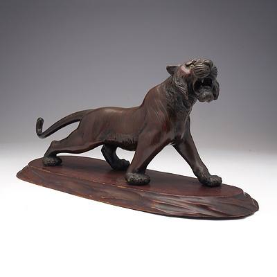 Japanese Patinated Bronze Model of a Stalking Tiger on a Carved Wood Base, Meiji Period 1868-1912