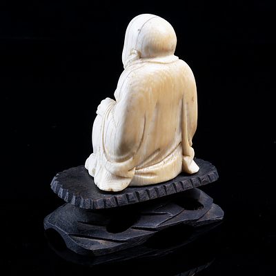 An Ivory Buddha on a Wooden Carved Base