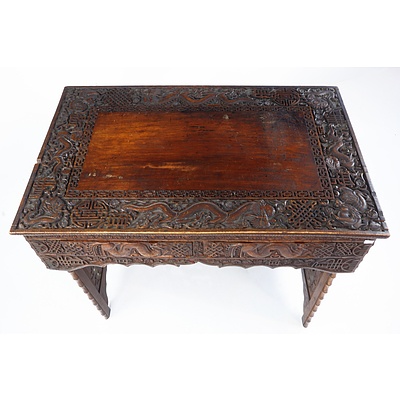 South Chinese or Burmese Teak Campaign Desk Profusely Carved with Dragons and Auspicious Symbols, Circa 1900