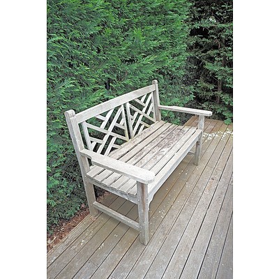 A Teak Two-Seater 'Chippendale' Style Garden Seat