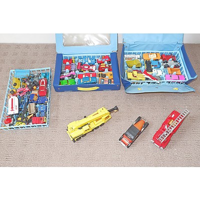 A Collection of Matchbox Cars and Trucks Including Two Carry Cases