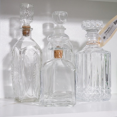 Four Vintage Crystal and Glass Lidded Decanters (4)