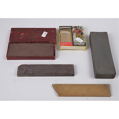 Four Vintage Sharpening Stones and a Boxed Ronson Typhoon Lighter