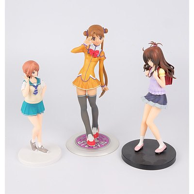 Three Anime Figurines on Stands