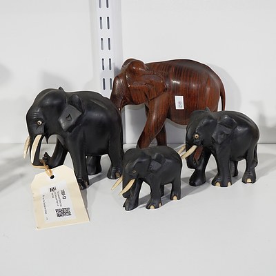 Three Graduated Ebony Elephant Carvings and One In Another Wood