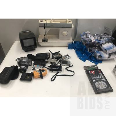 Assortment Of Digital And Still Cameras, Retro Mini TV, Toner Cartridges, Sewing Machine, Step Down Transformer And Other Items