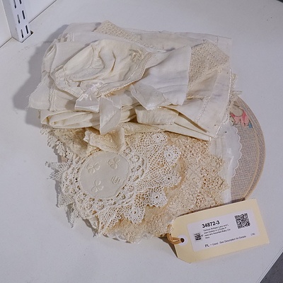 Various Antique Lace and Linen Doilies in a Doilie Press and Assorted Baby Clothes