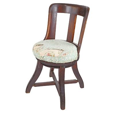 Antique Oak Framed Swivel Chair with Curved Back and Upholstered Cushion Seat