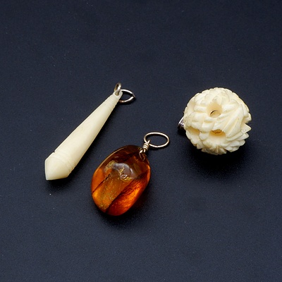 Two Bone Pendants and Another Amber
