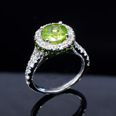 Sterling Silver Ring with Round Peridot Surrounded by White and Green CZ