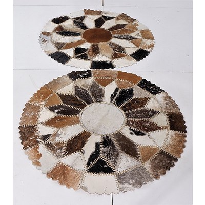 Two Woven Hide Rugs with Leather Stitching