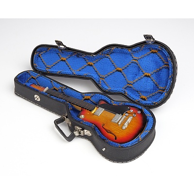 Ten Miniature Guitars and Other Instruments on Stands