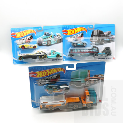 Three Boxed Hot Wheels Super Rigs, Including Driving Wild, District Transport and HW Park N Play
