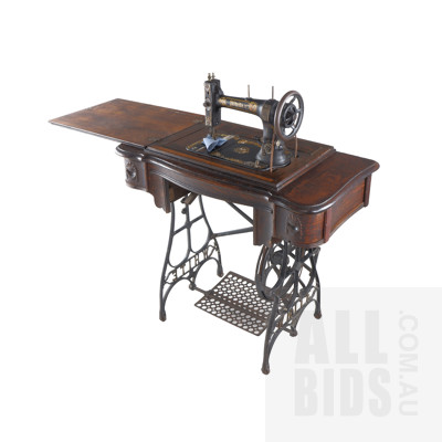 Antique White Treadle Sewing Machine with Cast Iron Base and Oak Cabinet