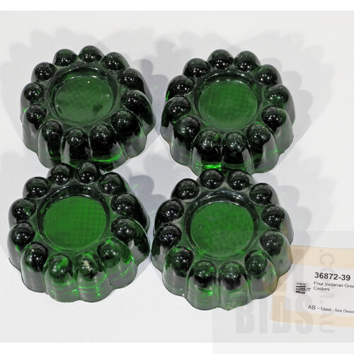 Four Victorian Green Glass Castors