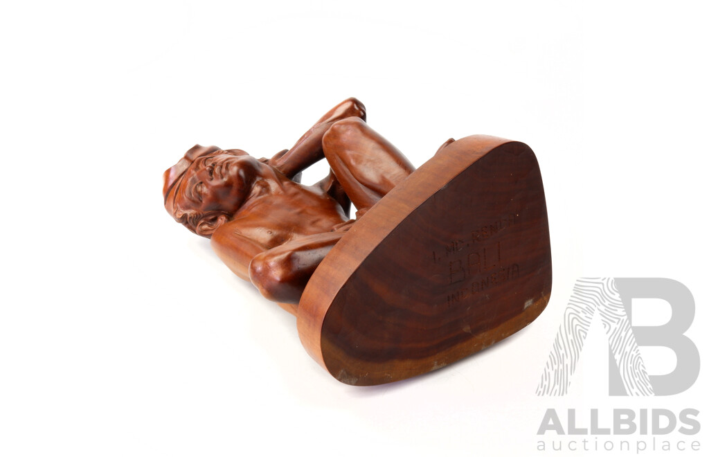 Good Mid Century Balinese Mahogany Wood Carving of a Crouching Man Signed ‘I MD Renda’, Height 34cm