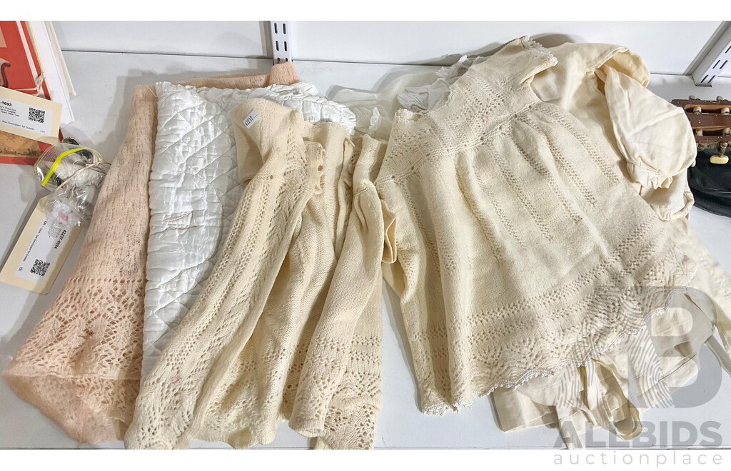 Collection of 1950’s Baby Clothes Including Three Handmade Smocks, One Knitted Dress and Jacket with Embroidered Rose Detail, Three Other Dresses Including a Handmade Lace One, a Peach Wool  Blanket, Small Satin Quilt and Pair of Original Used Baby Shoes
