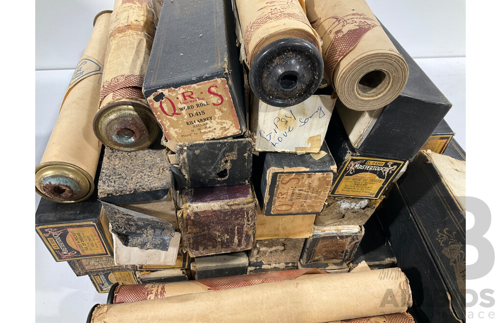 A collection of vintage pianola rolls, approximately 45