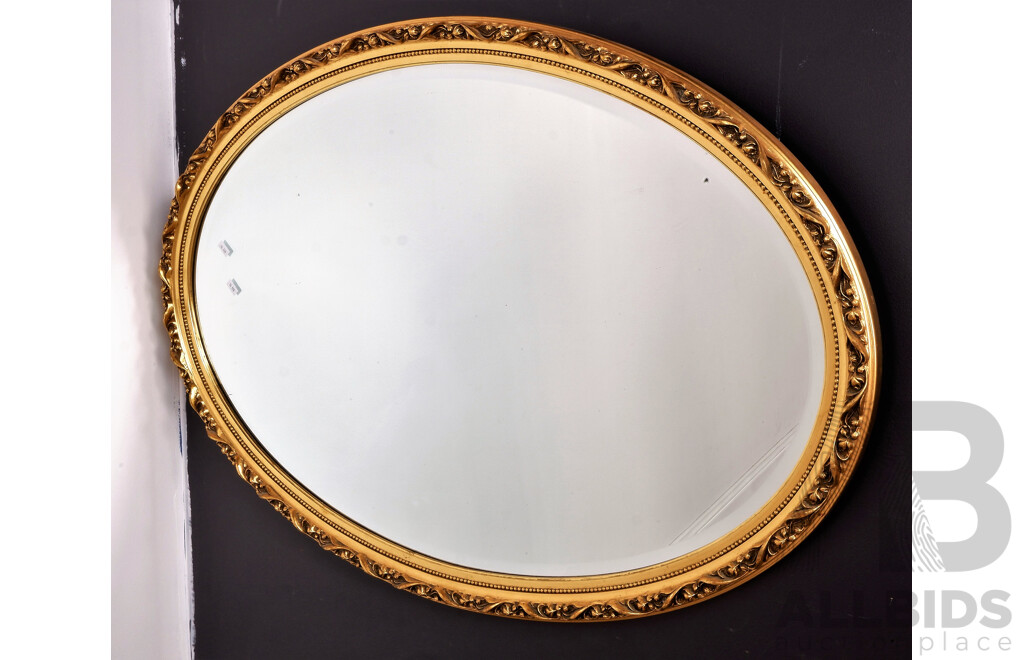 A Vintage Oval Mirror with Ornate Gold Frame