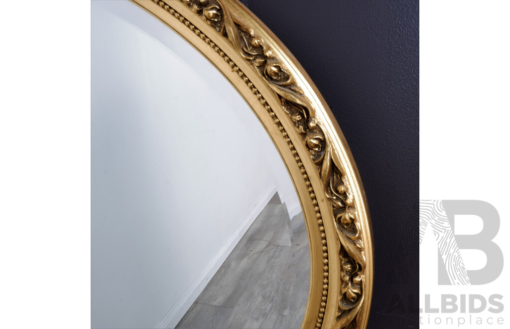 A Vintage Oval Mirror with Ornate Gold Frame