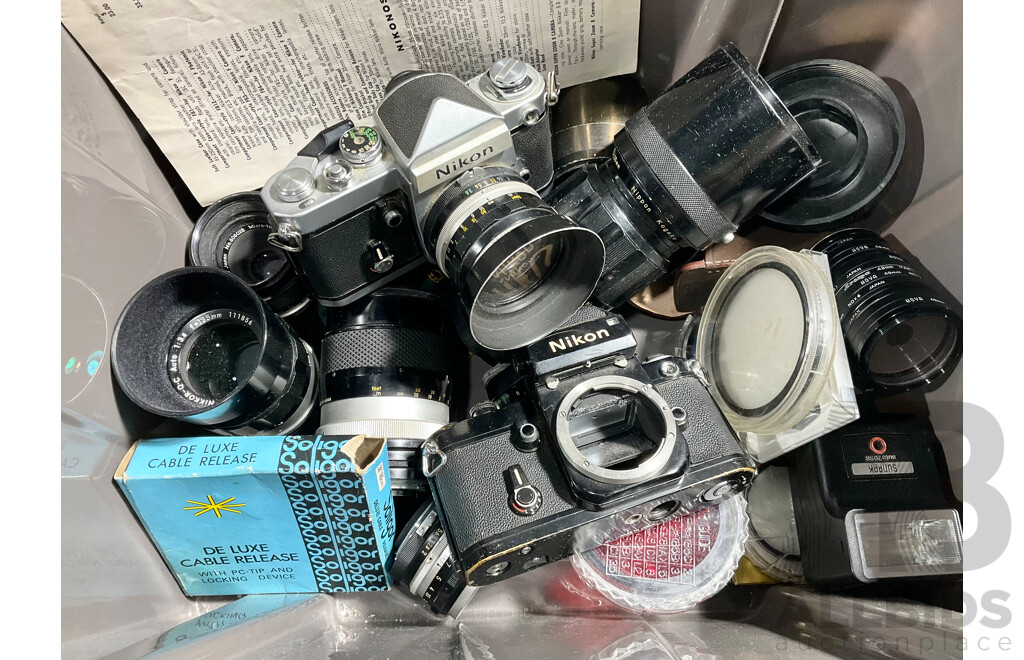 Pair of Nikon F2 SLR Cameras with Various Lenses