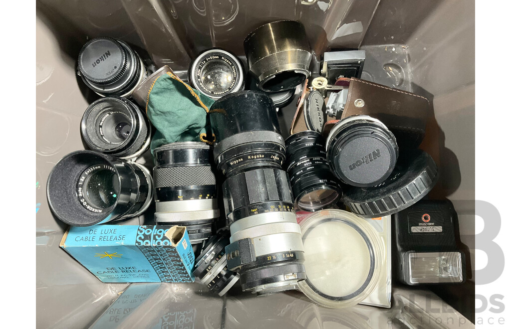 Pair of Nikon F2 SLR Cameras with Various Lenses