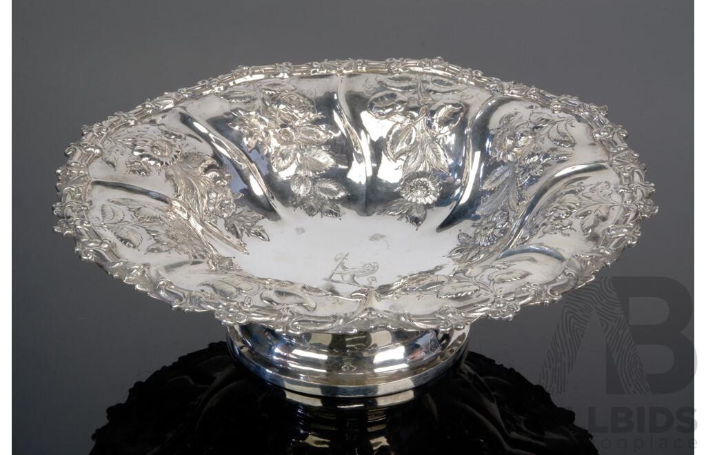 Antique Sterling Silver George IV Centerpiece Bowl with Repoussé Floral Detail and Merlion with Axe Engraved Crest to Interior, London, 1891