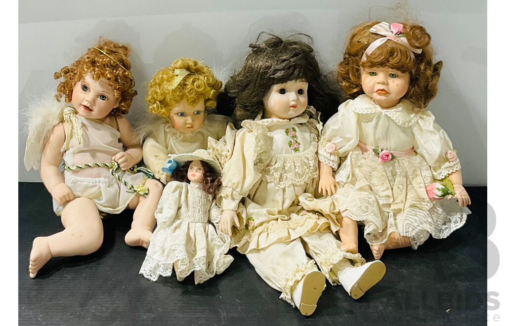 Collection of Five Porcelain Sitting Dolls Including Two Angels, One Mini Doll, a Crying Doll and More