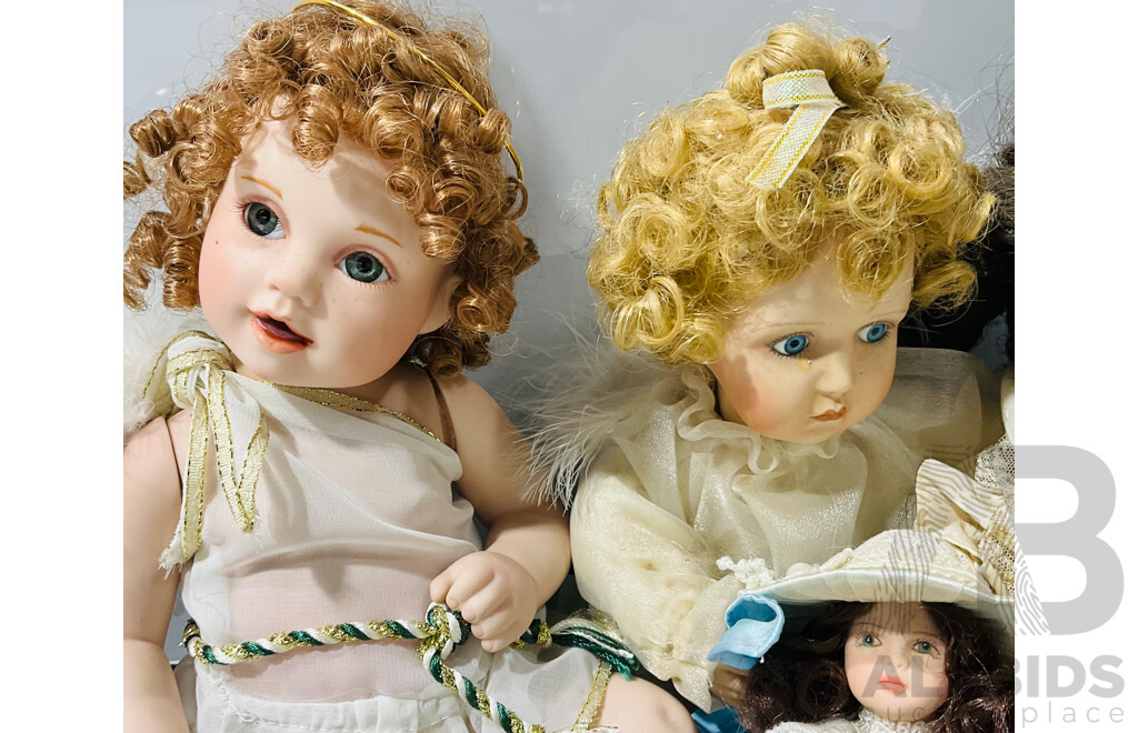 Collection of Five Porcelain Sitting Dolls Including Two Angels, One Mini Doll, a Crying Doll and More