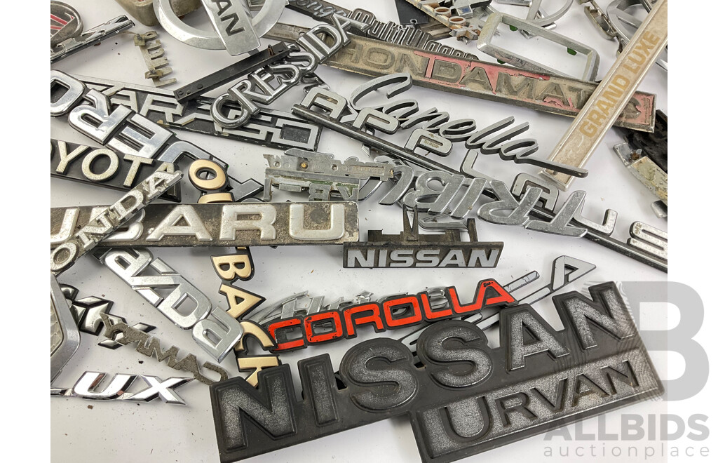 Collection of Vintage and Modern Japanese Automotive Badges Including Toyota, Honda, Subaru, Nissan, Daihatsu