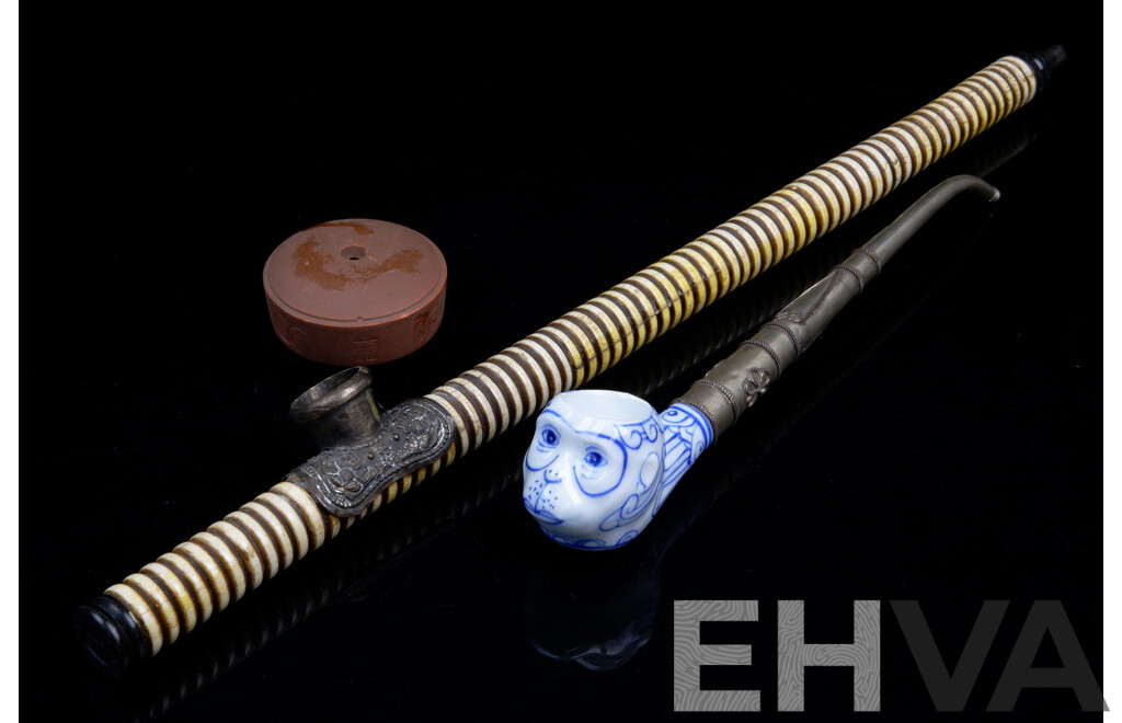 Vintage Asian Bone, Ebony Opium Pipe with White Metal Repousse Bowl Along with Monkey Faced Blue and White Porcelain Example with Metal Stem