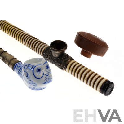 Vintage Asian Bone, Ebony Opium Pipe with White Metal Repousse Bowl Along with Monkey Faced Blue and White Porcelain Example with Metal Stem