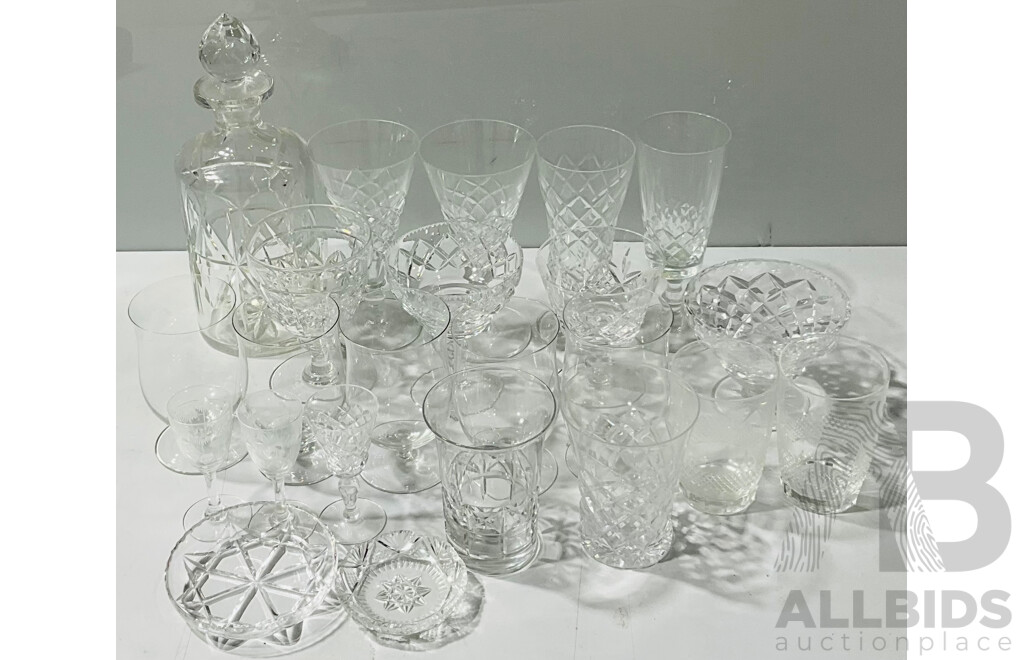 Collection of Vintage Crystal Glassware in Varied Sizes and Styles Alongside Decanter