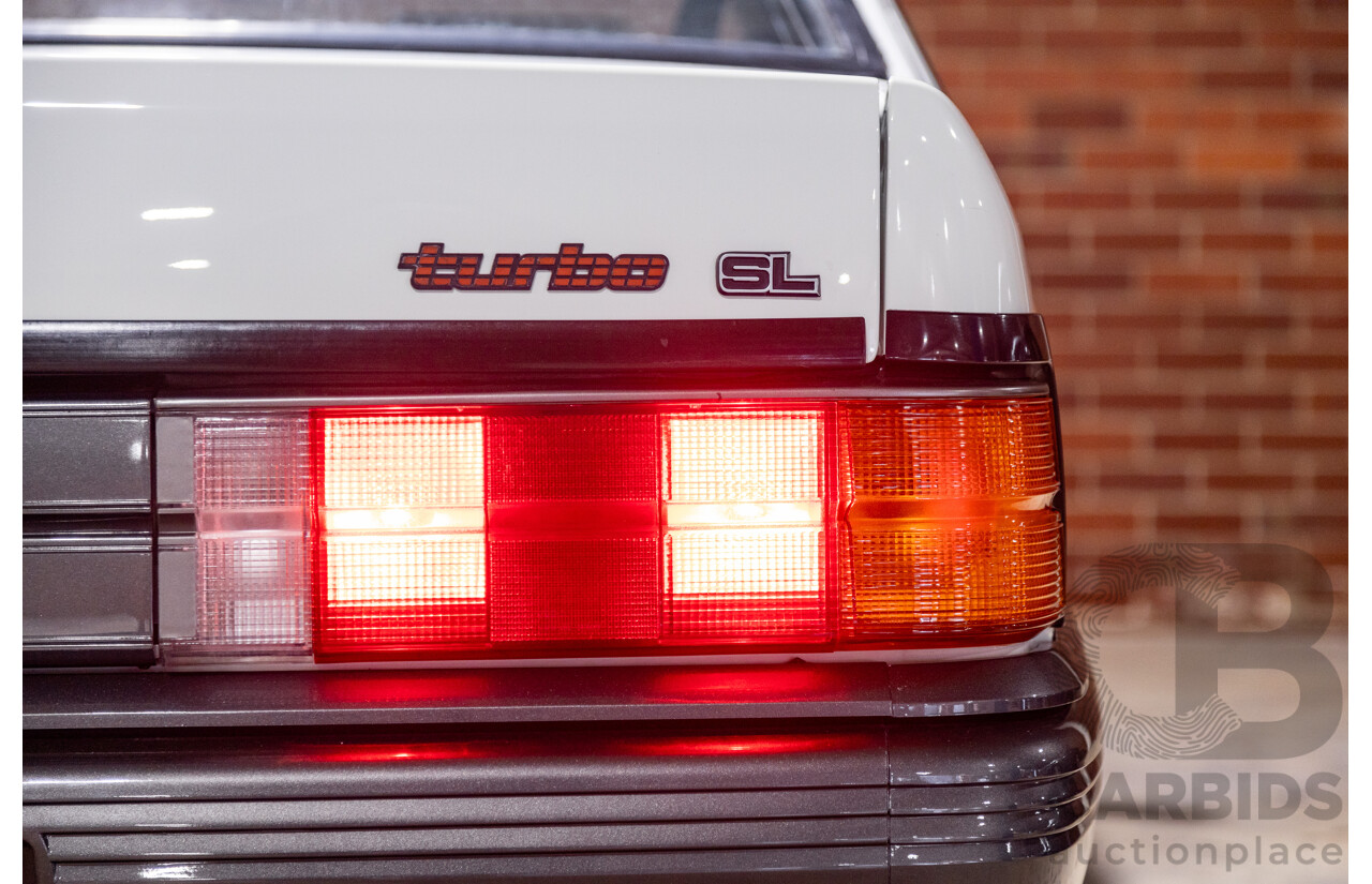 6/1987 Holden Commodore VL Turbo SL BT1 4d Sedan White Turbo 3.0L - Ex-Police - Modified