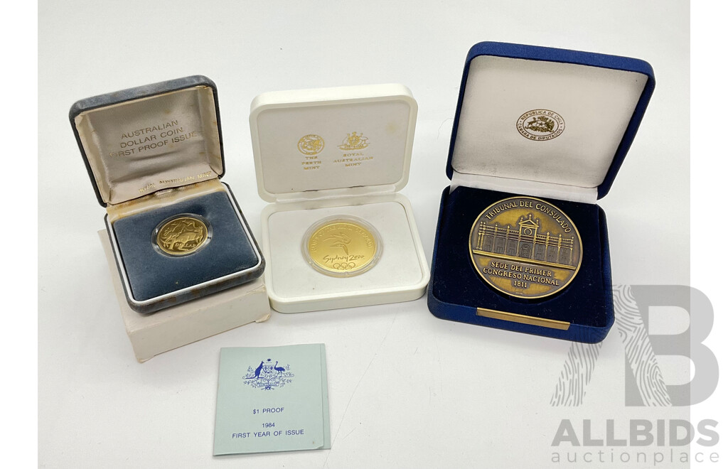 Three Commemorative Coins Including Australian 1984 One Dollar Proof Coin, 2000 Olympics Gold Series Coin and Chile Consulate/Chamber of Deputies Court Medal