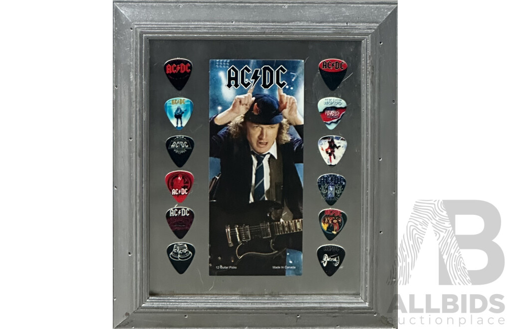 Collection of Twelve Framed AC/DC Guitar Picks Alongside an Image of Angus Young, 32 x 27 cm (frame)