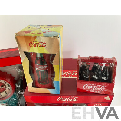 Assortment of Coca Cola Items Including Moulded Wall Clock, Bank Alarm Clock, Diecast Vehicles, Tins, Cups, Collector and Cooking Books