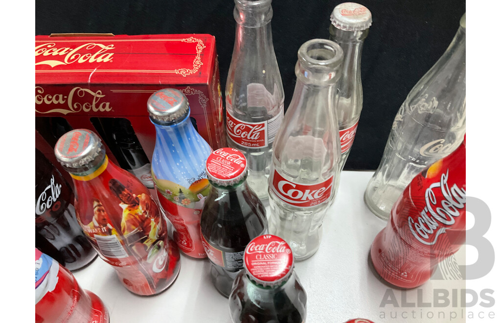 Collection of Vintage and Commemorative Coca Cola Bottles Including Christmas, Olympics and 1987 America's Cup