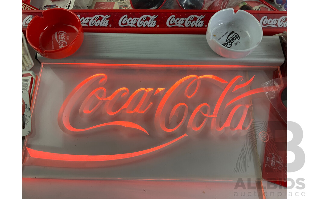 Assortment of Coca Cola Merchandise Including Hanging Illuminated Sign, Lip Smackers, Ice Trays, Pens, Sunglasses, Wallet and More