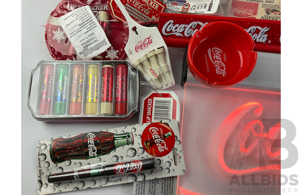 Assortment of Coca Cola Merchandise Including Hanging Illuminated Sign, Lip Smackers, Ice Trays, Pens, Sunglasses, Wallet and More