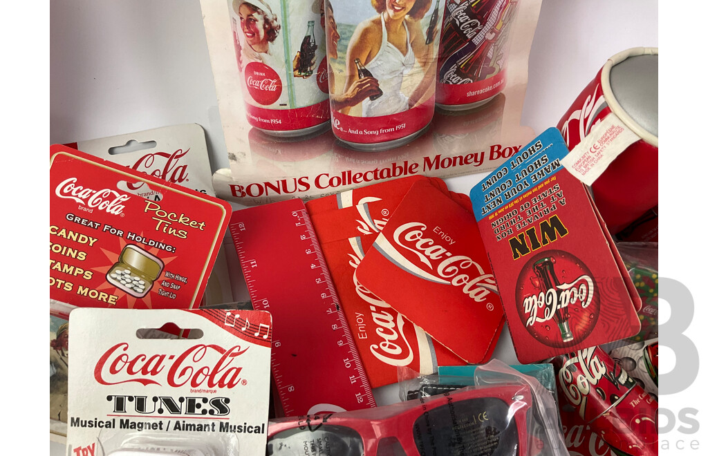 Assortment of Coca Cola Merchandise Including Hanging Illuminated Sign, Lip Smackers, Ice Trays, Pens, Sunglasses, Wallet and More