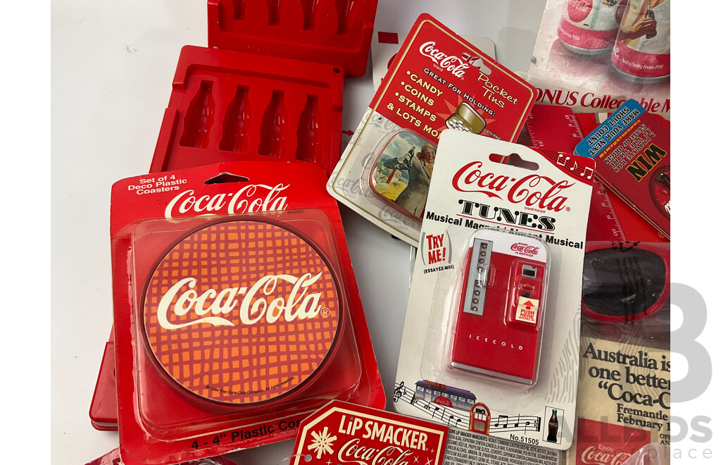 Assortment of Coca Cola Merchandise Including Hanging Illuminated Sign, Lip Smackers, Ice Trays, Pens, Sunglasses, Wallet and More