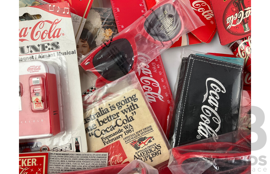 Assortment of Coca Cola Merchandise Including Hanging Illuminated Sign, Lip Smackers, Ice Trays, Pens, Sunglasses, Wallet and More