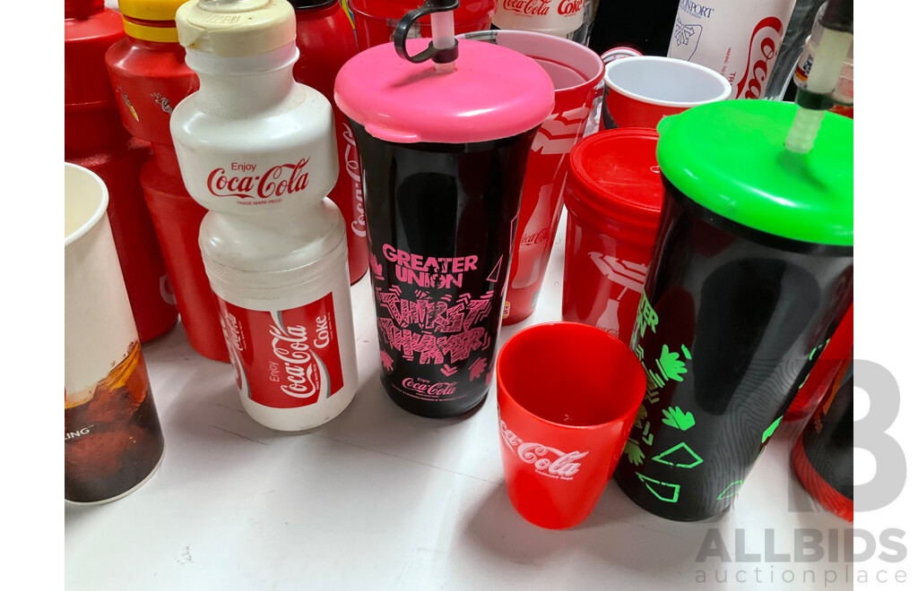 Collection of Coca Cola Sports Drink Bottles and Movie Cups