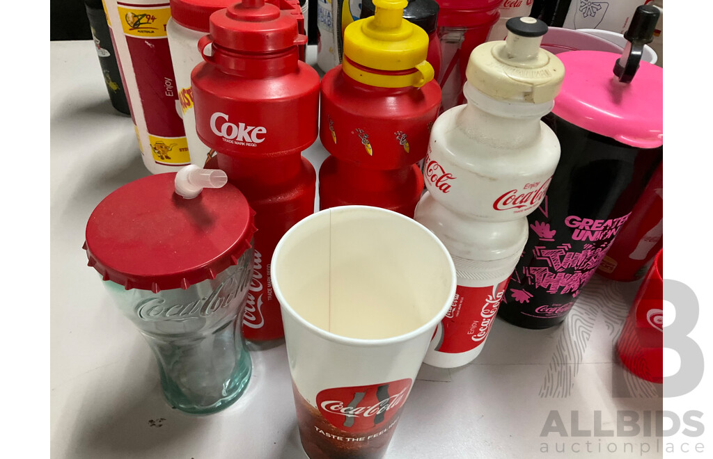 Collection of Coca Cola Sports Drink Bottles and Movie Cups