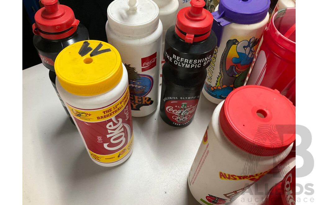 Collection of Coca Cola Sports Drink Bottles and Movie Cups