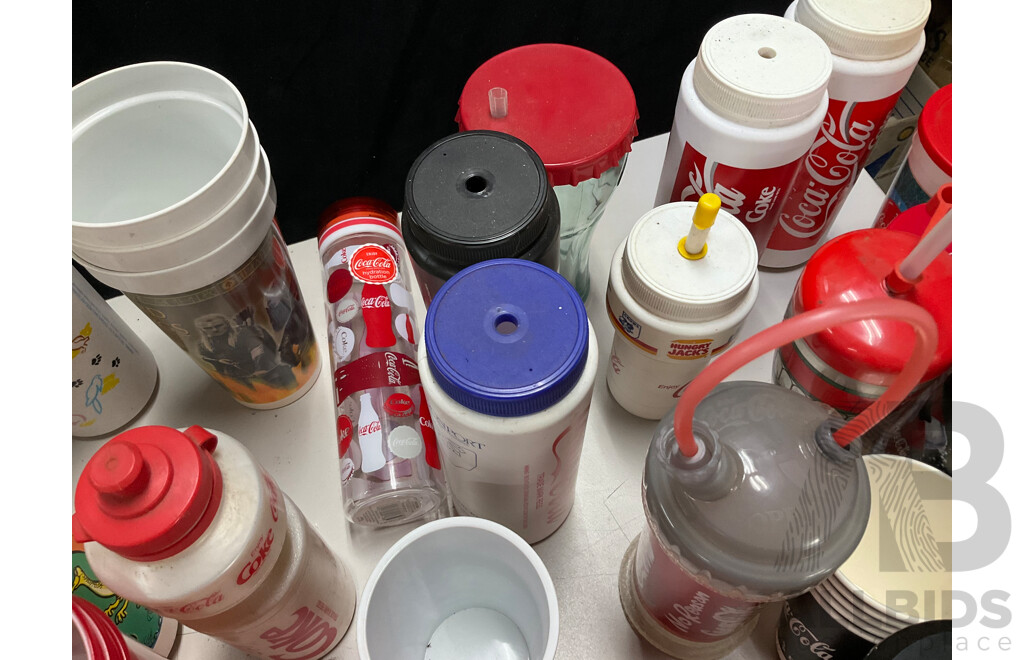 Collection of Coca Cola Sports Drink Bottles and Movie Cups