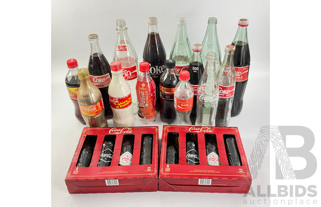 Collection of New and Old Coca Cola Bottles Including Tall Glass One Liter and Plastic T Shirt in a Bottle