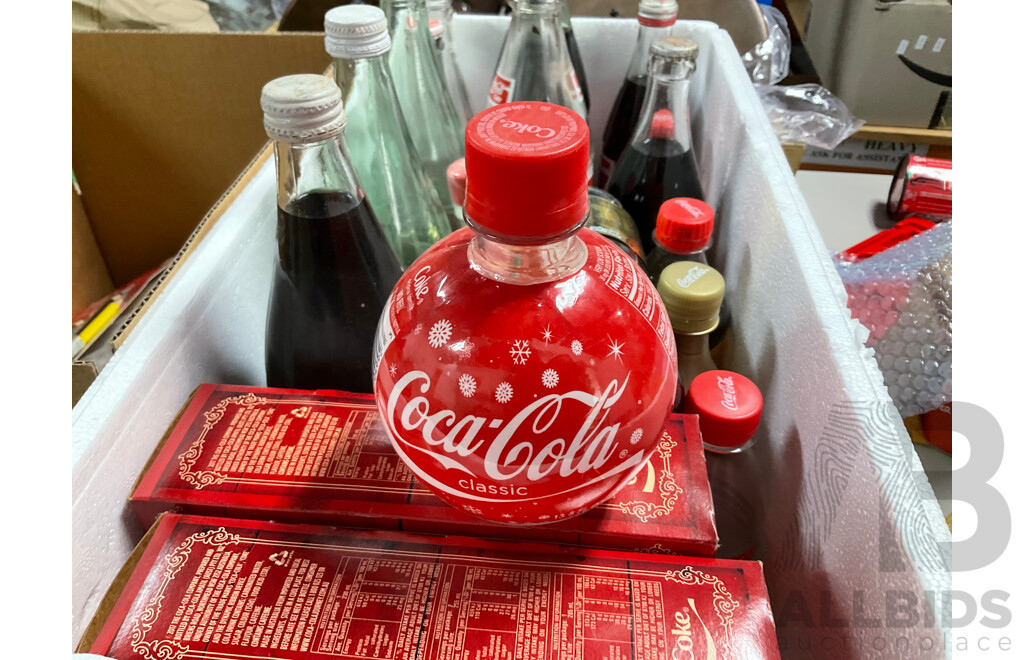 Collection of New and Old Coca Cola Bottles Including Tall Glass One Liter and Plastic T Shirt in a Bottle