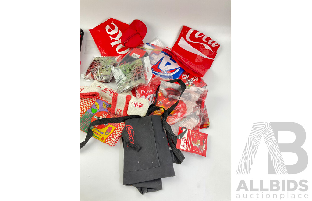 Assortment of Coca Cola Wallets, Tea Towels, Bags, Socks, Sweat Bands, Oven Mitt and Ponchos